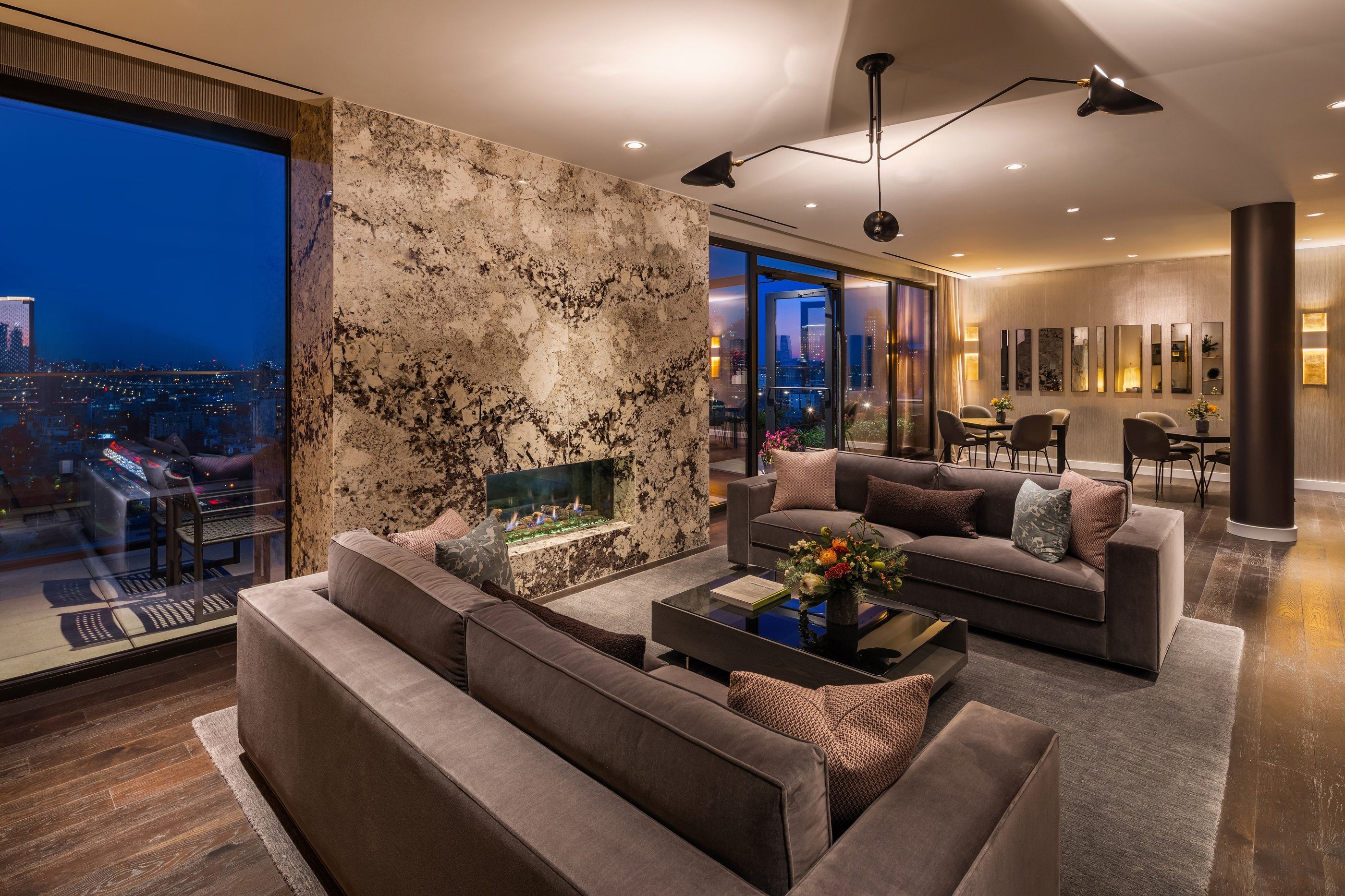 Living room with a book-matched stone fireplace wall